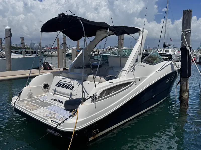 Slide: The Image of 2012 Sea Ray 330 Sundancer docked at marina under cloudy sky. - 1