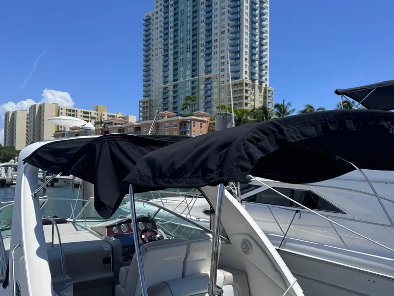 Slide: The Image of 2012 Sea Ray 330 Sundancer docked with cityscape background. - 10
