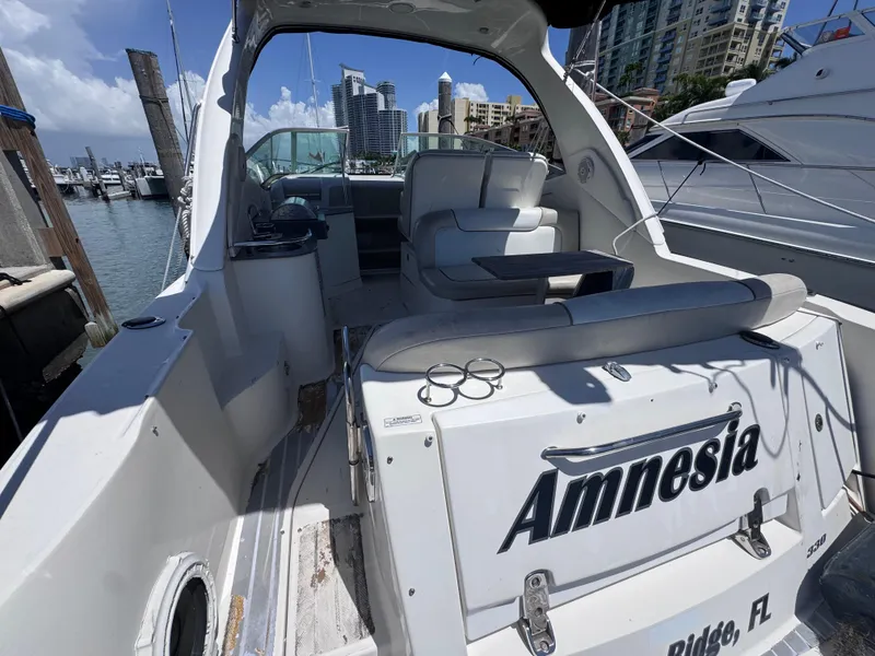 Slide: The Image of 2012 Sea Ray 330 Sundancer docked at marina, featuring spacious seating and modern design. - 11
