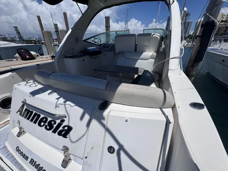 Slide: The Image of 2012 Sea Ray 330 Sundancer docked, featuring spacious seating and sleek design. - 12