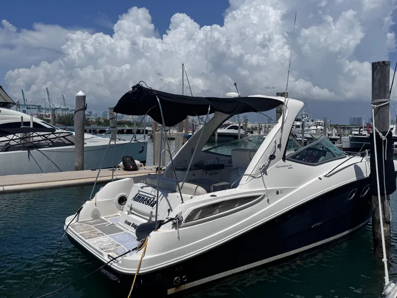Slide: The Image of 2012 Sea Ray 330 Sundancer docked at marina under cloudy sky. - 2