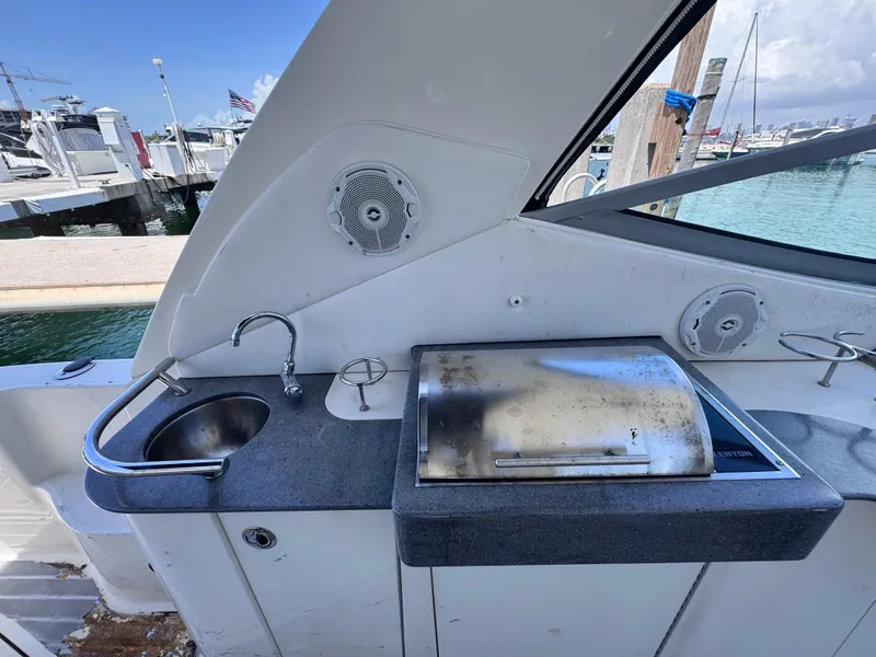 Slide: The Image of Outdoor kitchenette on 2012 Sea Ray 330 Sundancer yacht with sink and grill at marina. - 20