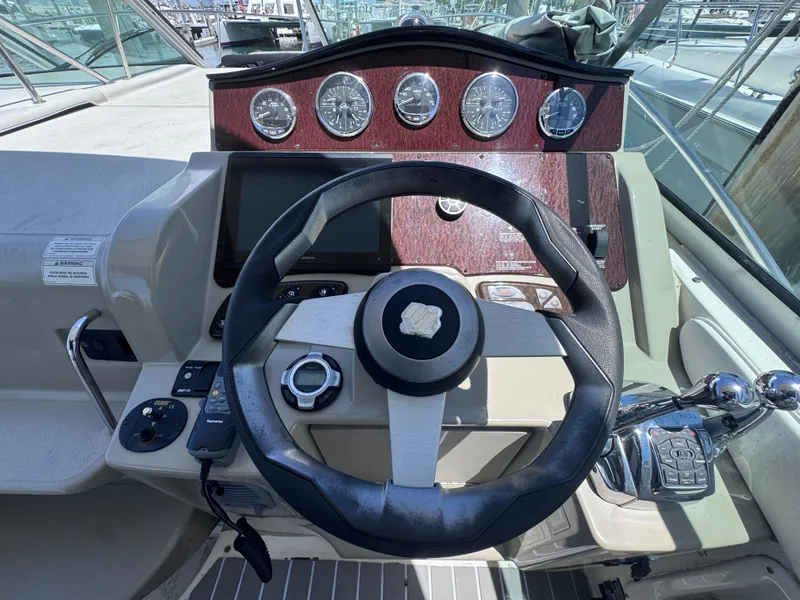 Slide: The Image of Cockpit of 2012 Sea Ray 330 Sundancer with steering wheel and control panel. - 22