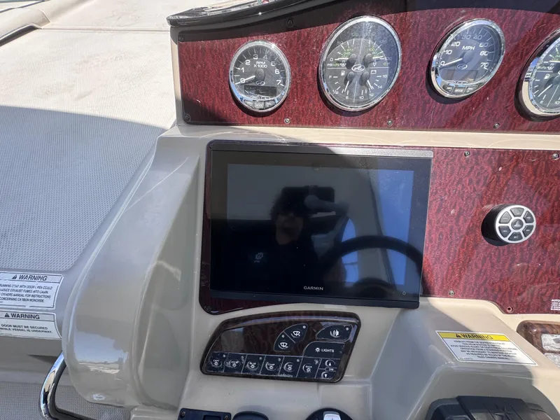 Slide: The Image of Dashboard of 2012 Sea Ray 330 Sundancer with Garmin display and gauges. - 23