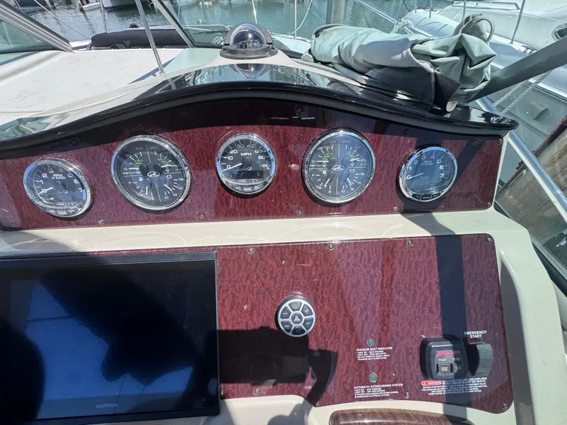 Slide: The Image of Dashboard of a 2012 Sea Ray 330 Sundancer boat with gauges and controls. - 24
