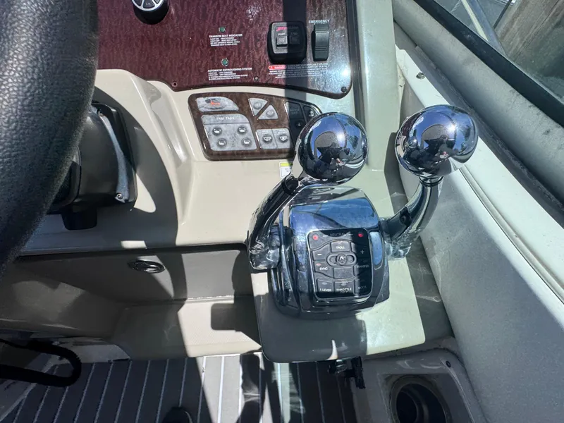 Slide: The Image of Control panel of a 2012 Sea Ray 330 Sundancer boat with dual throttle levers. - 25