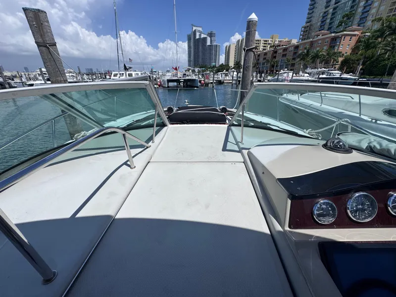 Slide: The Image of 2012 Sea Ray 330 Sundancer yacht docked at marina with city skyline. - 26