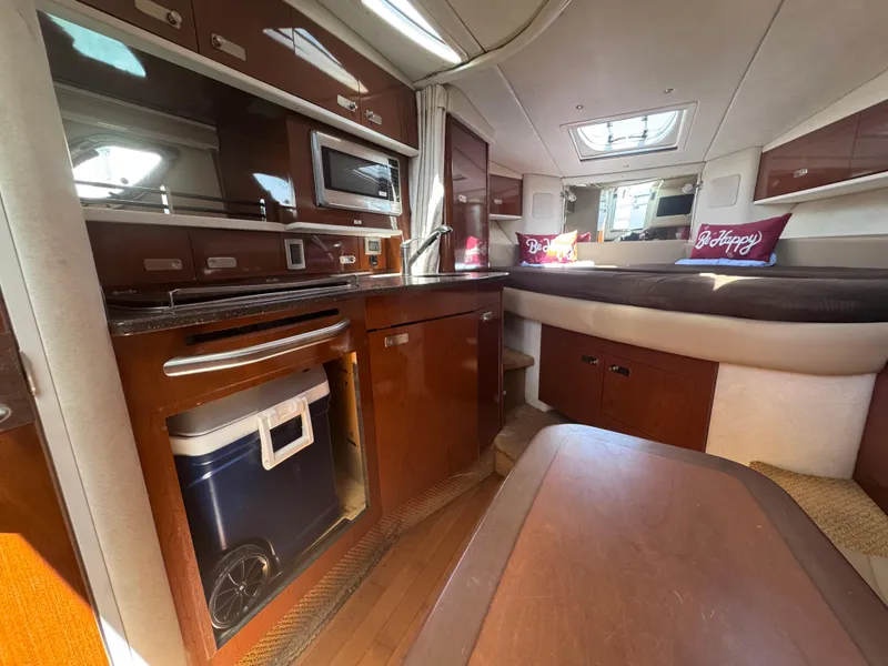 Slide: The Image of Interior of 2012 Sea Ray 330 Sundancer yacht with kitchen and cozy seating area. - 27