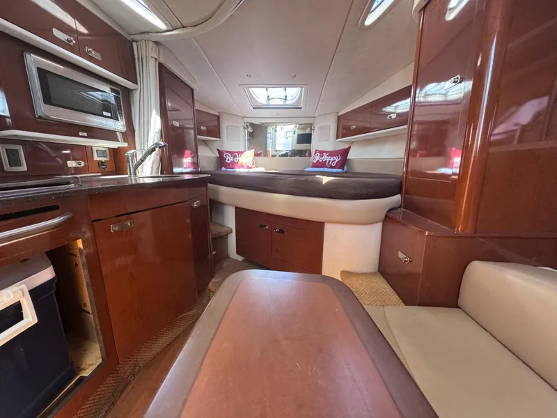 Slide: The Image of Interior of 2012 Sea Ray 330 Sundancer yacht with kitchen and cozy seating area. - 28
