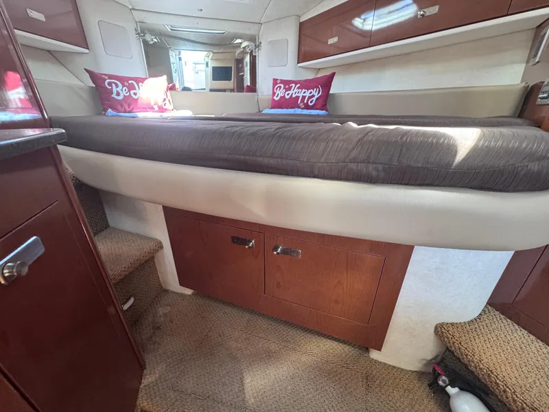 Slide: The Image of Interior cabin of 2012 Sea Ray 330 Sundancer with bed and storage cabinets. - 30