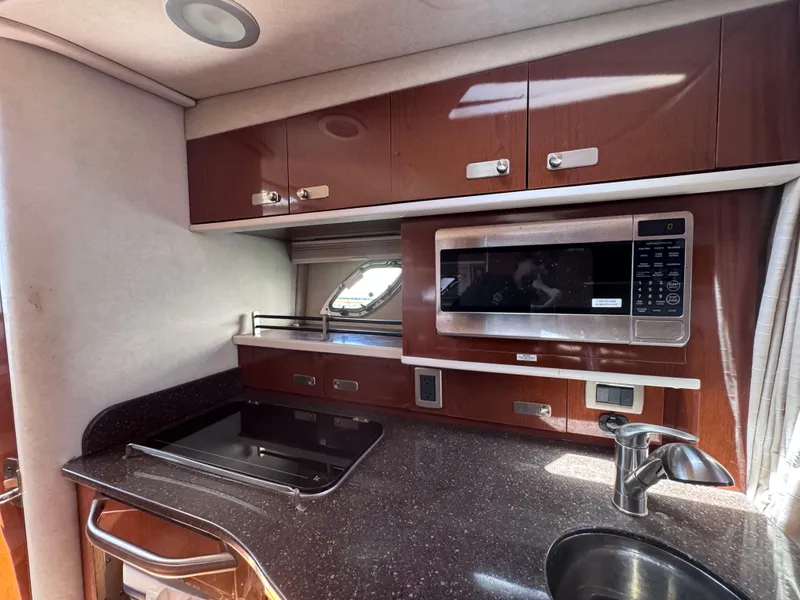 Slide: The Image of Luxurious 2012 Sea Ray 330 Sundancer galley with microwave, stove, and sink. - 31