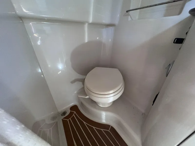 Slide: The Image of 2012 Sea Ray 330 Sundancer bathroom with toilet and wooden floor. - 42