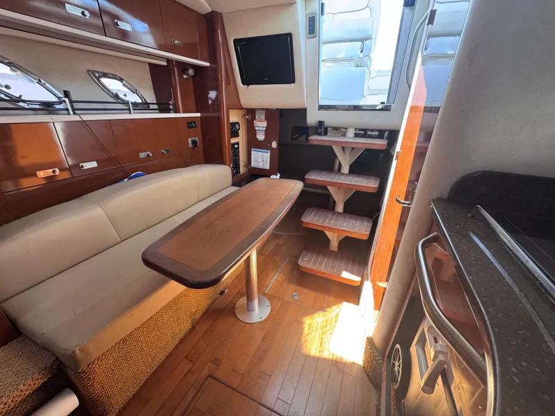 Slide: The Image of Interior of 2012 Sea Ray 330 Sundancer with seating, table, and stairs. - 44
