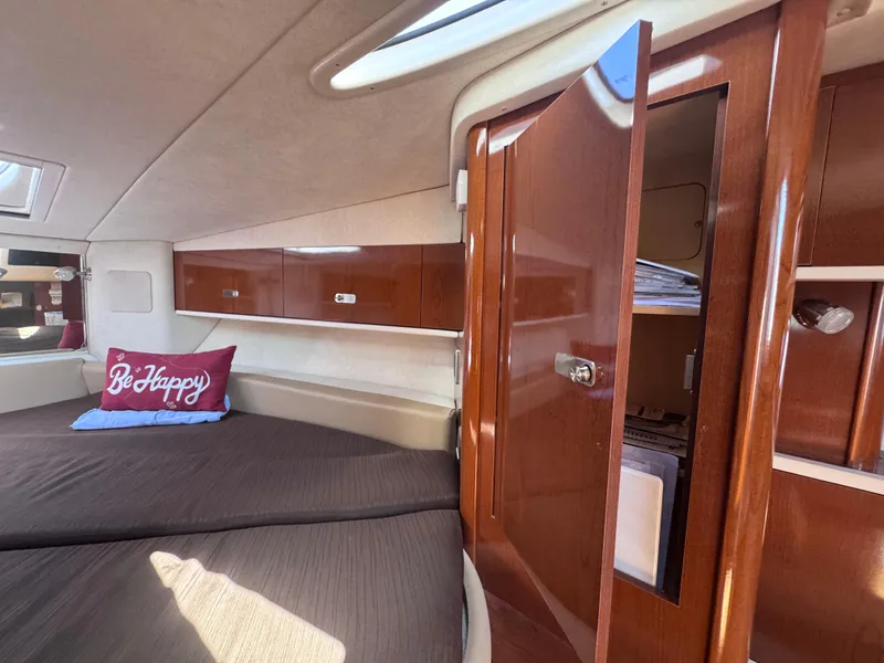 Slide: The Image of Interior of 2012 Sea Ray 330 Sundancer with cozy bed and wooden cabinetry. - 46