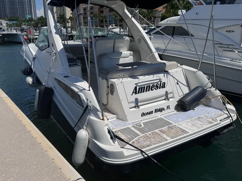 Slide: The Image of 2012 Sea Ray 330 Sundancer docked, named "Amnesia," in Ocean Ridge, FL marina. - 6