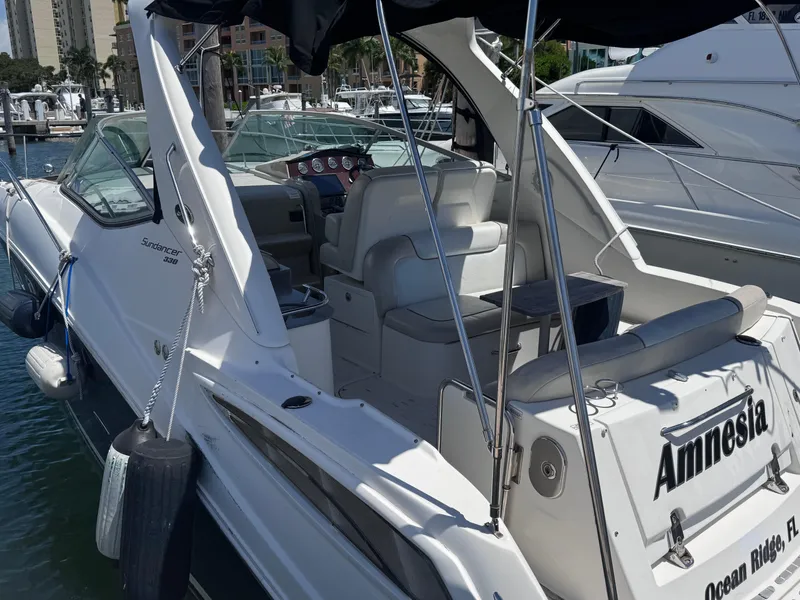 Slide: The Image of Sea Ray 330 Sundancer 2012 docked, featuring spacious seating and sleek design. - 7