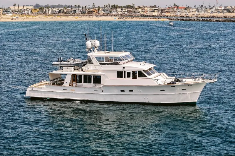 The Image of 2006 Grand Banks 72 Yachtfisher cruising near a coastal cityscape. - 0