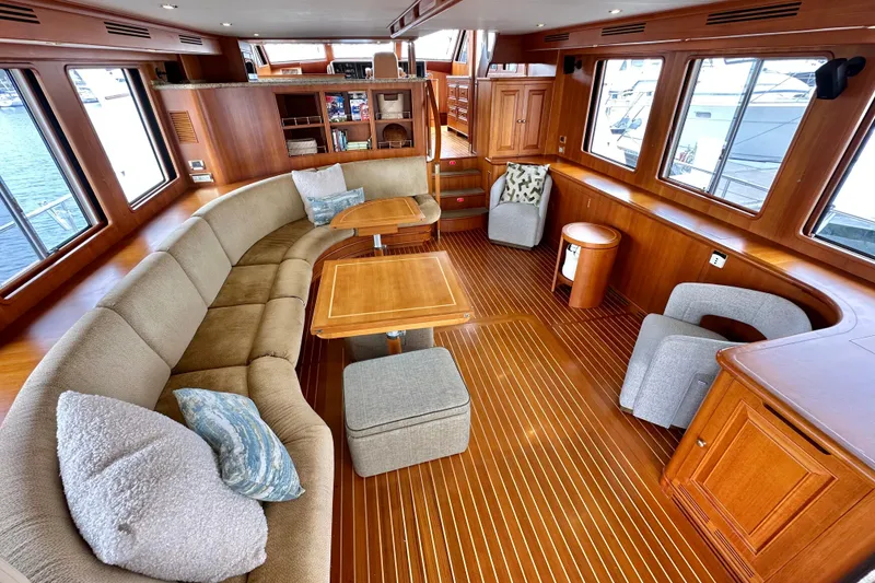 Slide: The Image of Luxurious 2006 Grand Banks 72 Yachtfisher interior with elegant wood finishes and plush seating. - 14