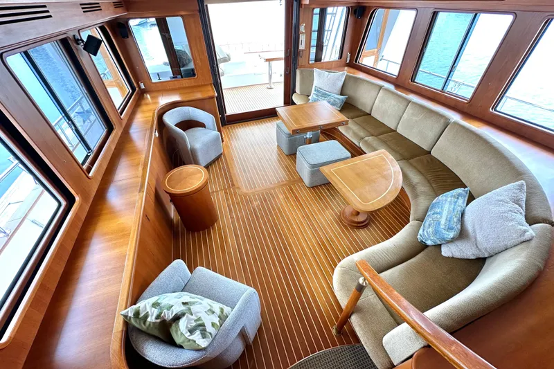 Slide: The Image of Luxurious interior of 2006 Grand Banks 72 Yachtfisher with elegant seating and wooden flooring. - 16