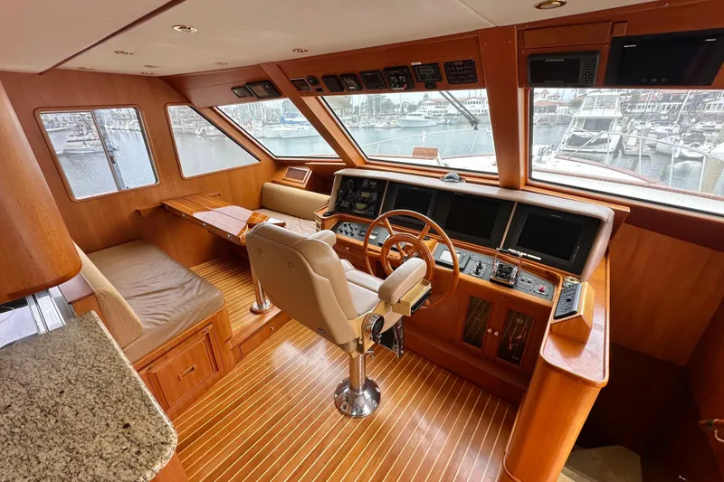 Slide: The Image of Luxurious 2006 Grand Banks 72 Yachtfisher helm with wood accents and panoramic windows. - 19