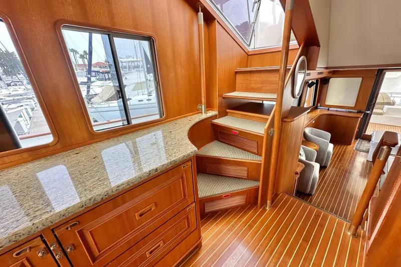 Slide: The Image of Luxurious interior of 2006 Grand Banks 72 Yachtfisher with wooden stairs and granite countertop. - 23