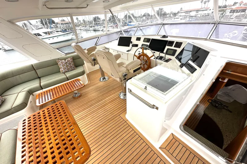 Slide: The Image of Luxurious 2006 Grand Banks 72 Yachtfisher interior with helm, seating, and wooden flooring. - 25