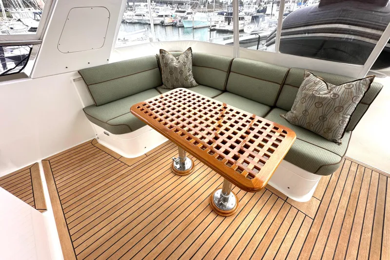 Slide: The Image of Luxurious 2006 Grand Banks 72 Yachtfisher interior with elegant seating and wooden table. - 29