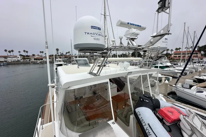Slide: The Image of 2006 Grand Banks 72 Yachtfisher docked, featuring advanced navigation equipment and spacious deck. - 33