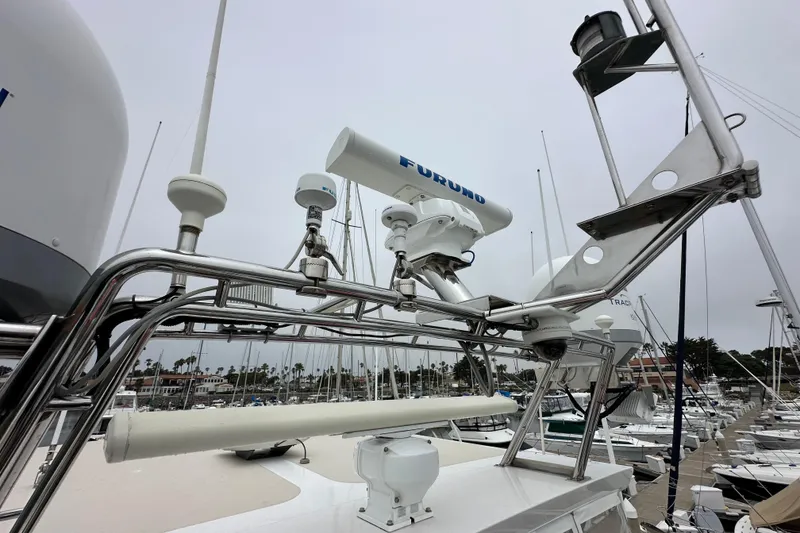 Slide: The Image of Radar equipment on a 2006 Grand Banks 72 Yachtfisher, docked at a marina. - 34