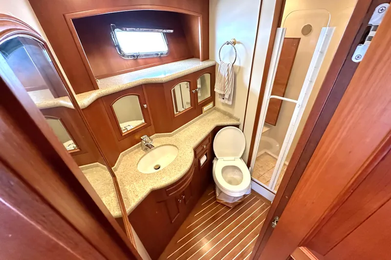 Slide: The Image of Luxurious bathroom in 2006 Grand Banks 72 Yachtfisher with wood accents and modern fixtures. - 36
