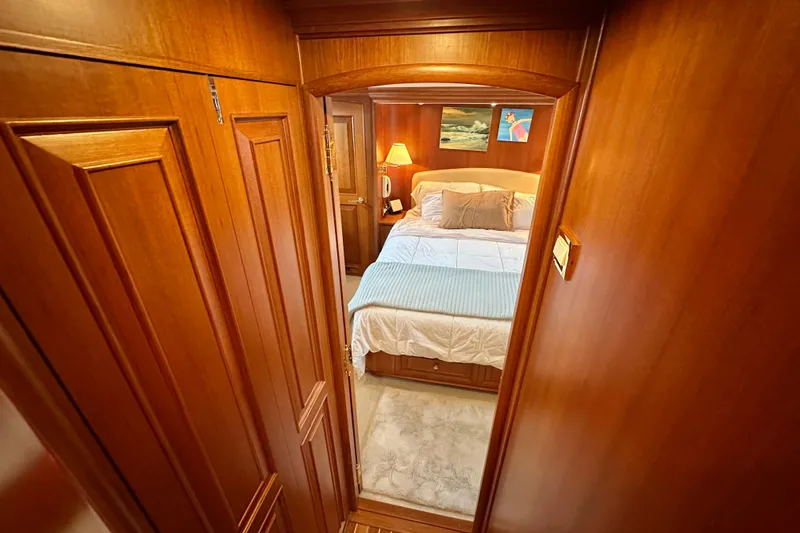 Slide: The Image of Luxurious bedroom interior of 2006 Grand Banks 72 Yachtfisher with wooden paneling and cozy bedding. - 40