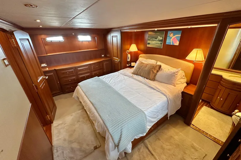 Slide: The Image of Luxurious bedroom interior of 2006 Grand Banks 72 Yachtfisher with elegant wood finish. - 42