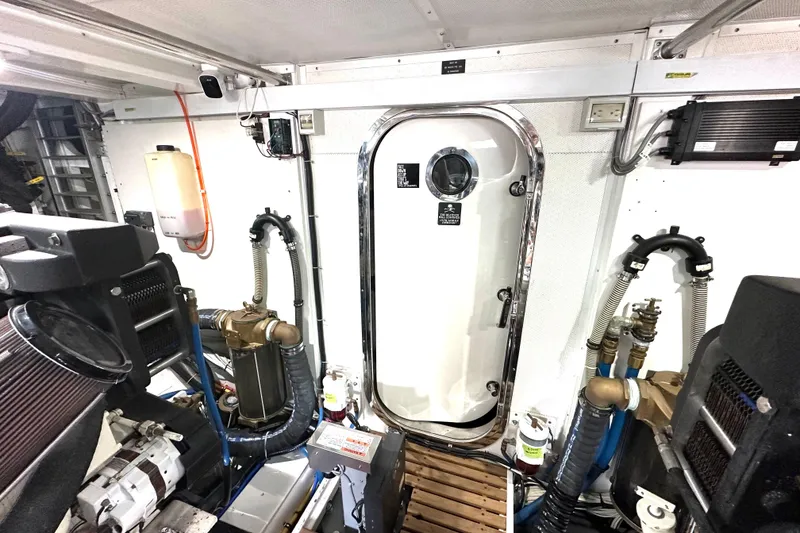 Slide: The Image of Engine room of 2006 Grand Banks 72 Yachtfisher with equipment and access door. - 45