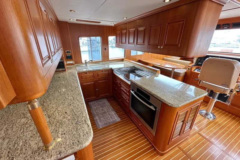 Slide: The Image of Luxurious 2006 Grand Banks 72 Yachtfisher interior with elegant wood cabinetry and granite countertops. - 21