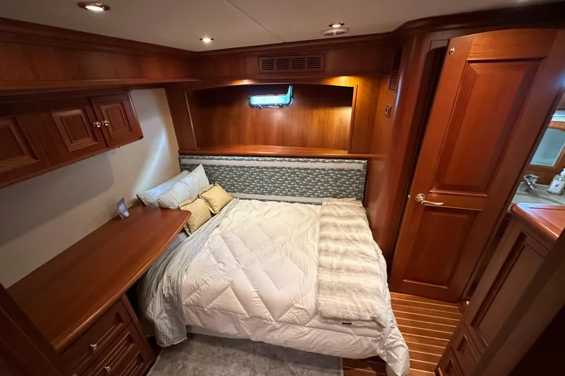 Slide: The Image of Luxurious 2006 Grand Banks 64 Aleutian yacht cabin with cozy bed and elegant wood finish. - 36