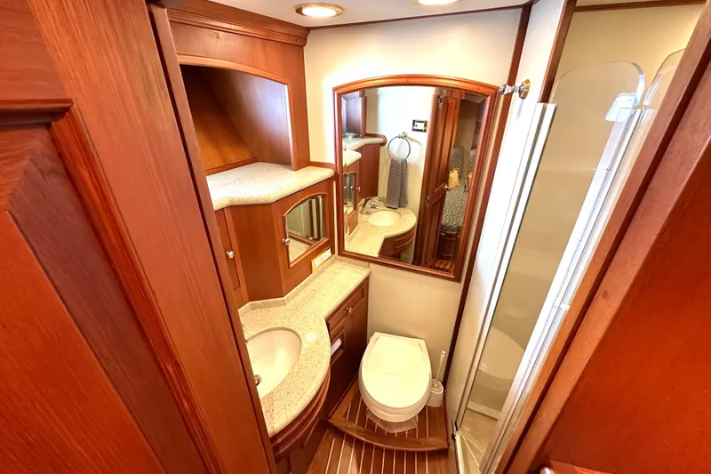 Slide: The Image of Luxurious 2006 Grand Banks 72 Yachtfisher bathroom with wood accents and modern amenities. - 38