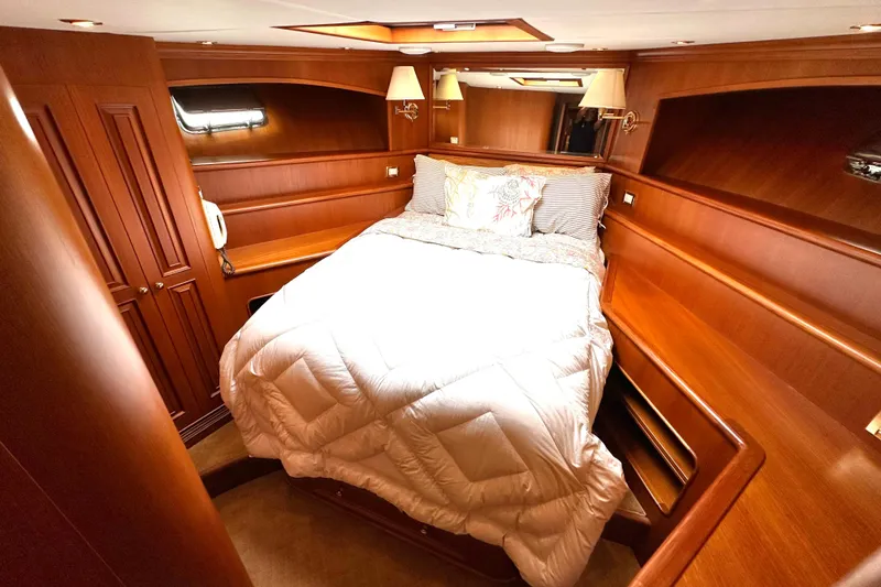 Slide: The Image of Luxurious 2006 Grand Banks 72 Yachtfisher cabin with elegant wood finish and cozy bedding. - 39