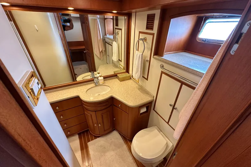 Slide: The Image of Luxurious bathroom in 2006 Grand Banks 72 Yachtfisher, featuring wood cabinetry and modern fixtures. - 44