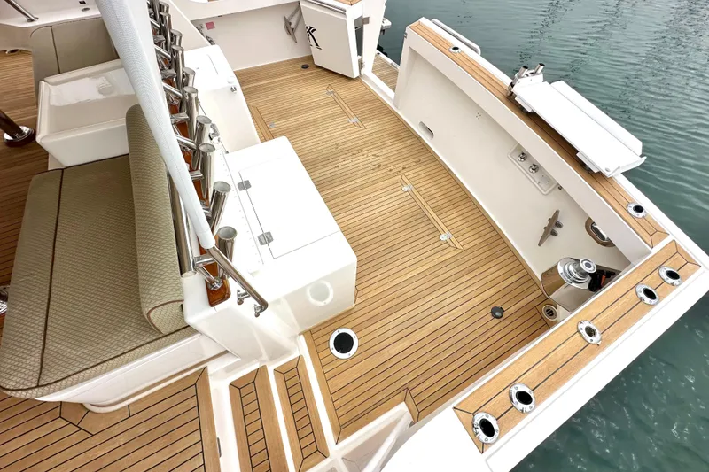 Slide: The Image of 2006 Grand Banks 72 Yachtfisher deck with teak flooring and fishing rod holders. - 6