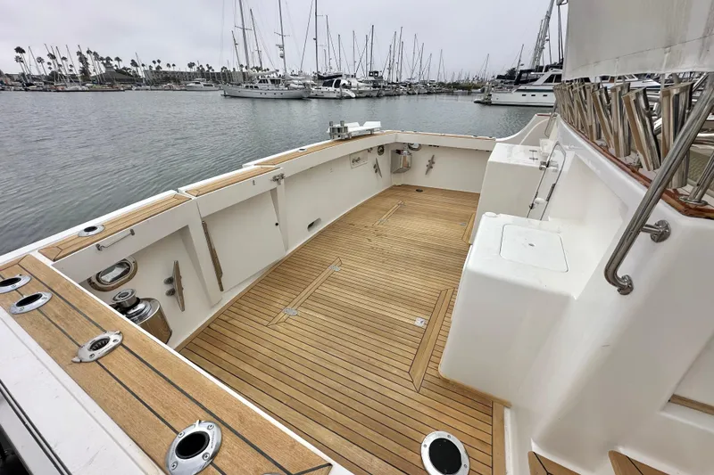 Slide: The Image of 2006 Grand Banks 72 Yachtfisher with teak deck, docked in a marina with sailboats. - 7