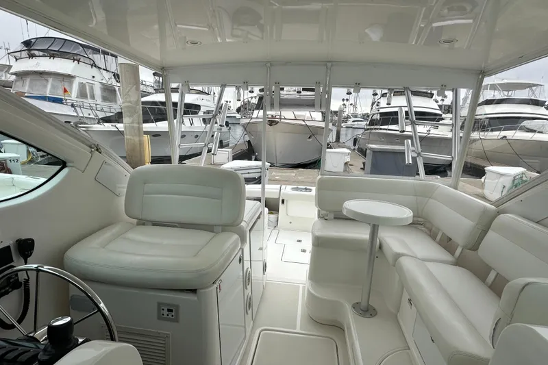 Slide: The Image of Interior of 2007 Tiara Yachts 3600, featuring white seating and marina view. - 11