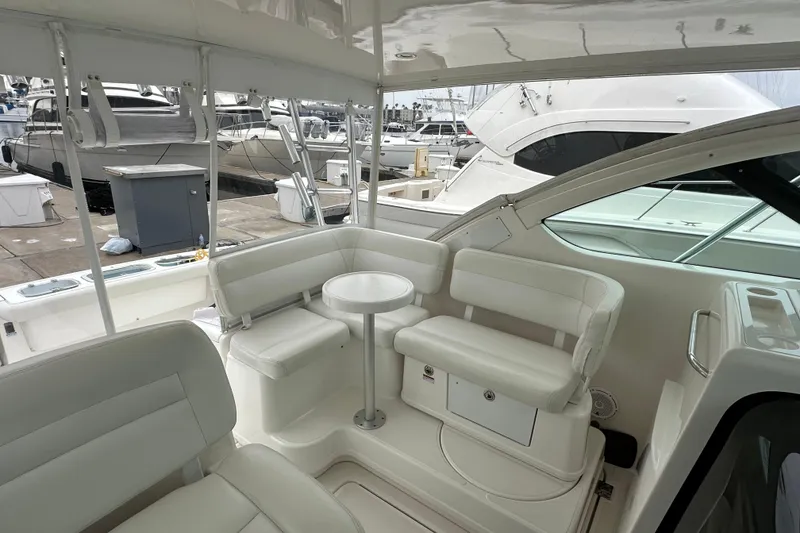 Slide: The Image of 2007 Tiara Yachts 3600 interior with white seating and table at marina. - 13