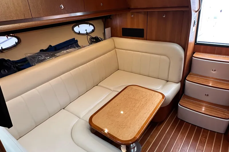 Slide: The Image of Luxurious interior of 2007 Tiara Yachts 3600 with cream seating and wooden accents. - 15