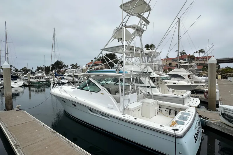 Slide: The Image of 2007 Tiara Yachts 3600 docked at a marina, surrounded by other boats. - 2