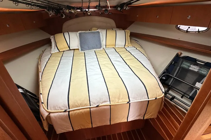 Slide: The Image of Cozy cabin interior of 2007 Tiara Yachts 3600 with striped bedding and wooden accents. - 21