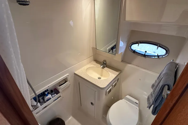 Slide: The Image of 2007 Tiara Yachts 3600 bathroom with sink, toilet, and porthole window. - 22