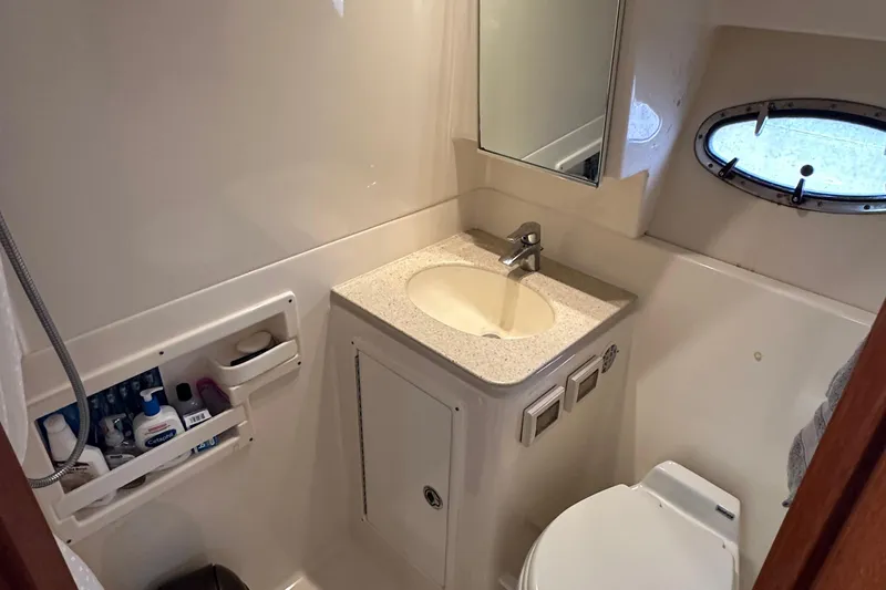 Slide: The Image of Bathroom interior of 2007 Tiara Yachts 3600, featuring sink, mirror, and porthole window. - 24