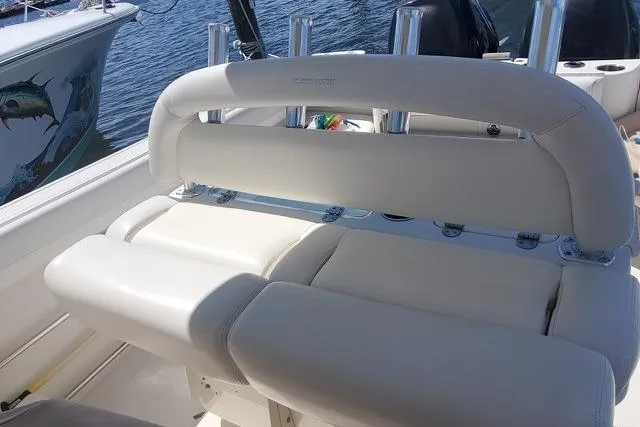 Slide: The Image of 2015 Sailfish 270 CC boat with rod holders against a blue sky background. - 10
