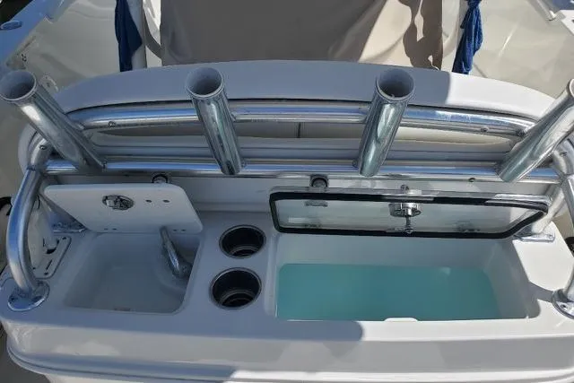 Slide: The Image of 2015 Sailfish 270 CC boat interior with cushioned seating and rod holders. - 11