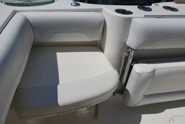 Slide: The Image of 2015 Sailfish 270 CC boat interior with Yeti cooler and cushioned seating. - 13